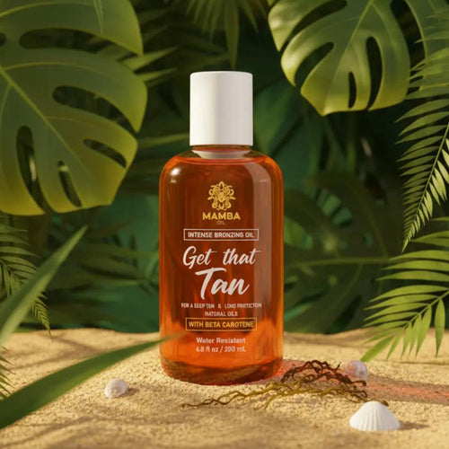 Bottle of Mamba tanning oil with tropical leaves in the background